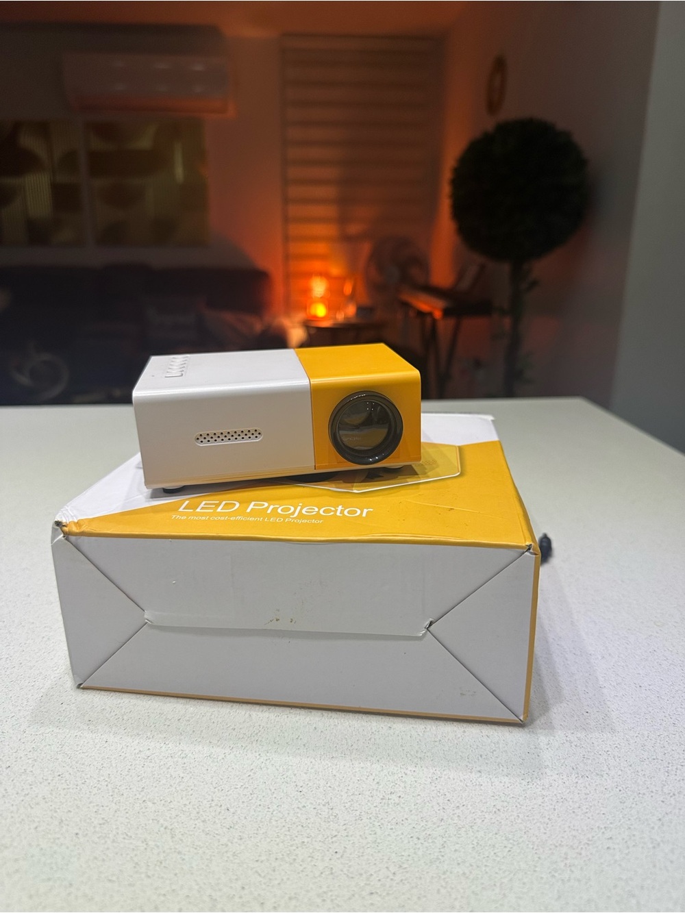 Compact Yellow and White LED Mini Projector - Portable Home Cinema.